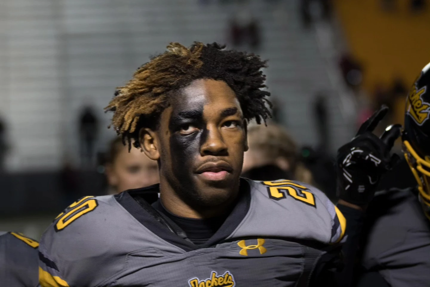 Portrait of a football player in uniform, looking toward the camera