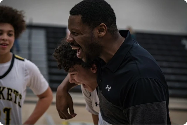 Coach and basketball team during a courtside moment