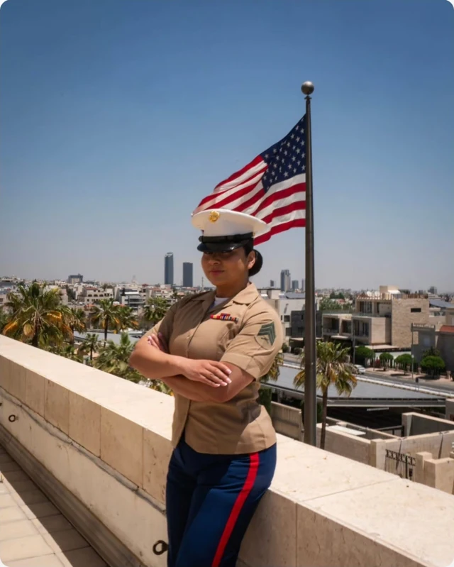 Outdoor portrait in military uniform beside an American flag